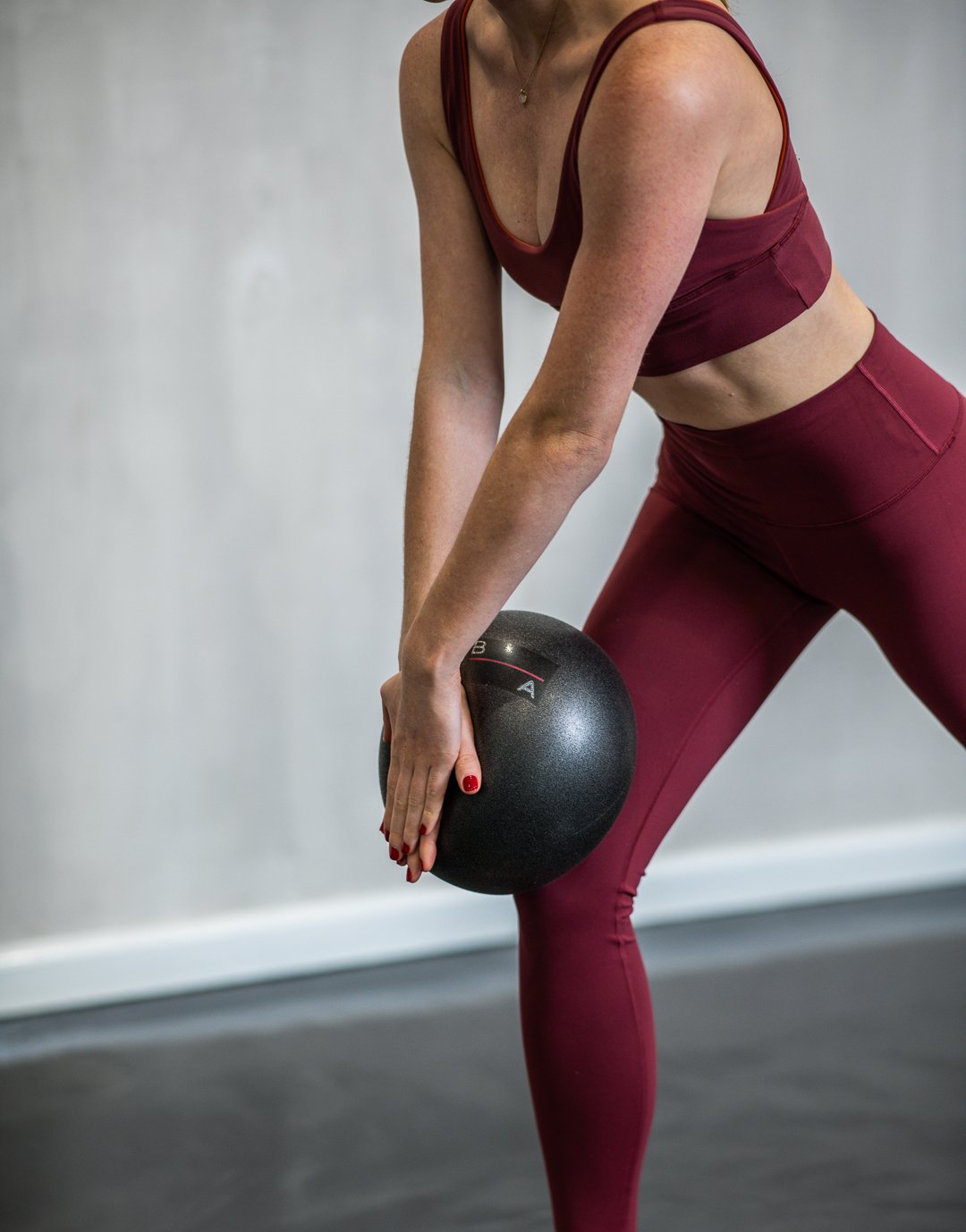 Female instructor using a soft pilates ball.